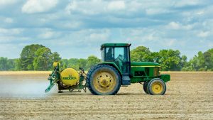 Photo of a Green and Yellow Tractor on Dirt