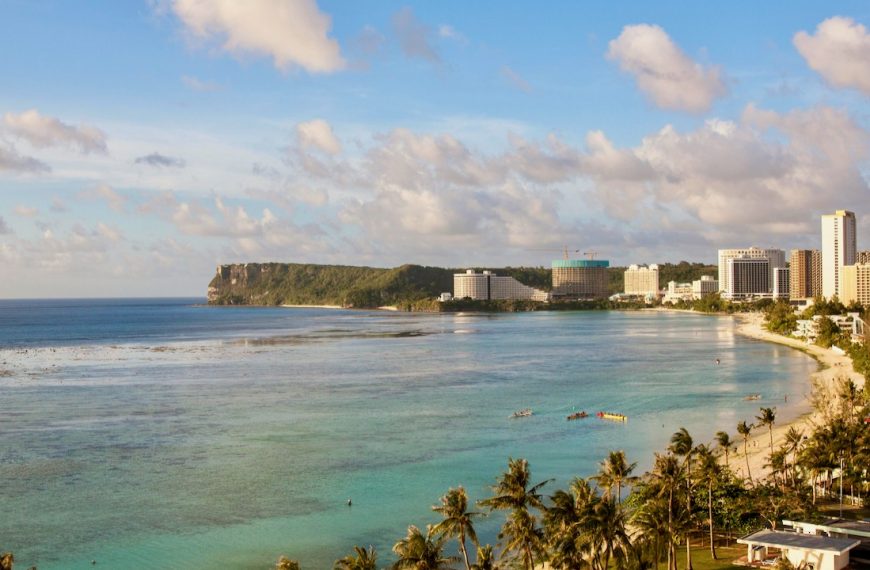 An Aerial Shot of a Shore with Buildings in Guam