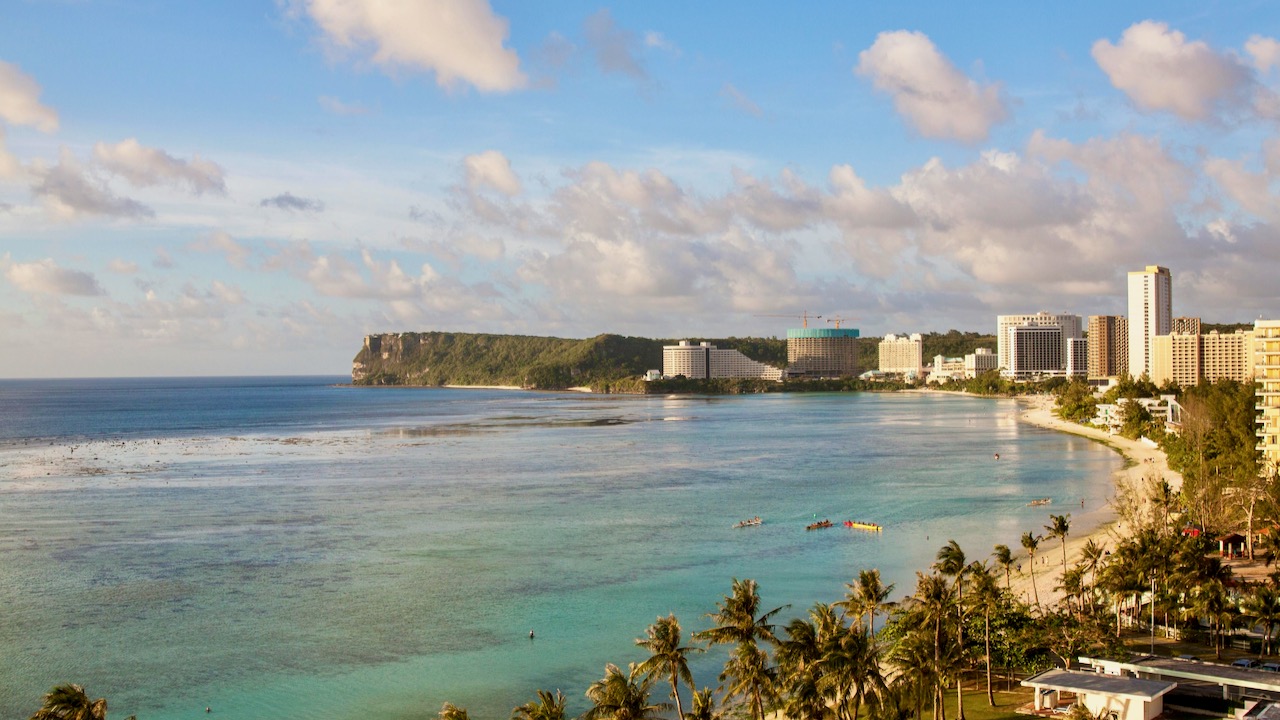 An Aerial Shot of a Shore with Buildings in Guam