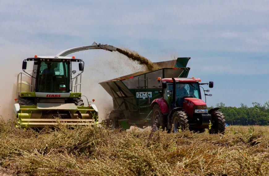 Photo of tractors working in a field during harvest in rural North Carolina on a clear day.